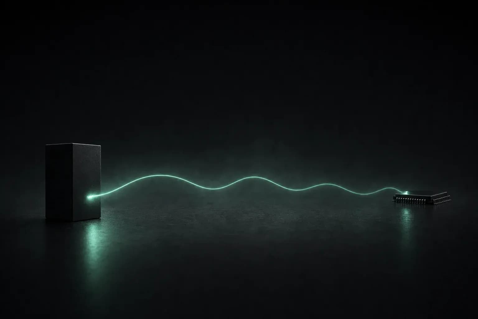 A matte black block on the left and a small electronic chip far to the right, joined by a thin emerald-glowing sine wave running over a dark floor.